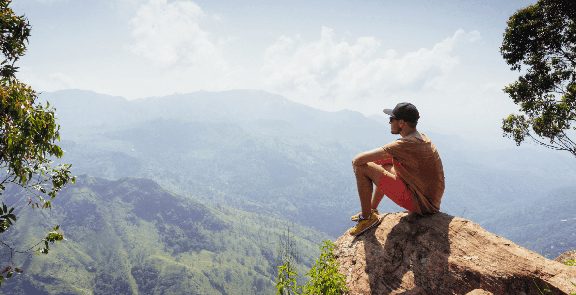 Stunning view from Ella Rock in Sri Lanka, featuring lush green valleys, misty hills, and scenic trekking pathways.