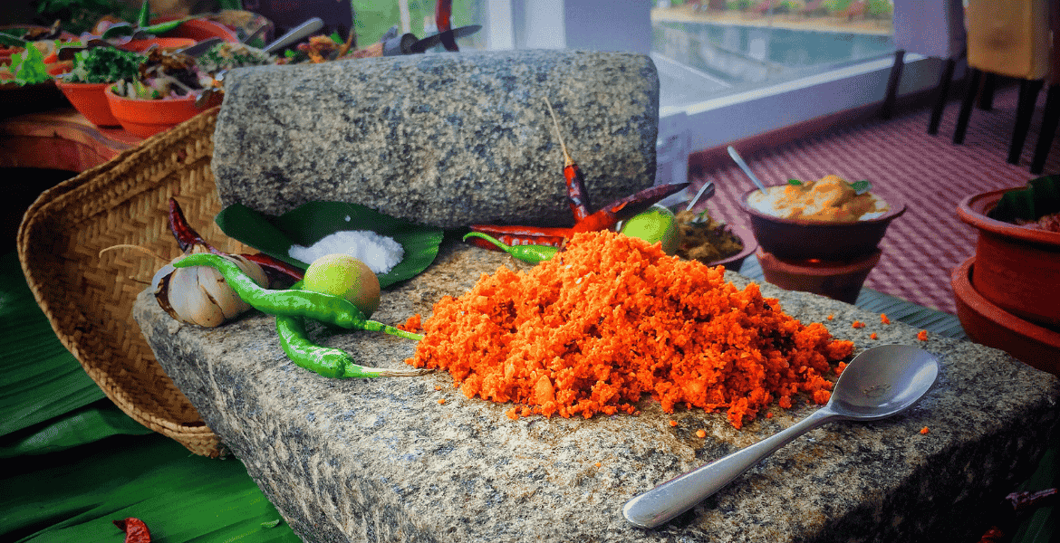 Traditional Sri Lankan Pol Sambal made with freshly grated coconut, red chili, onion, and lime is served as a spicy side dish with rice and curry.
