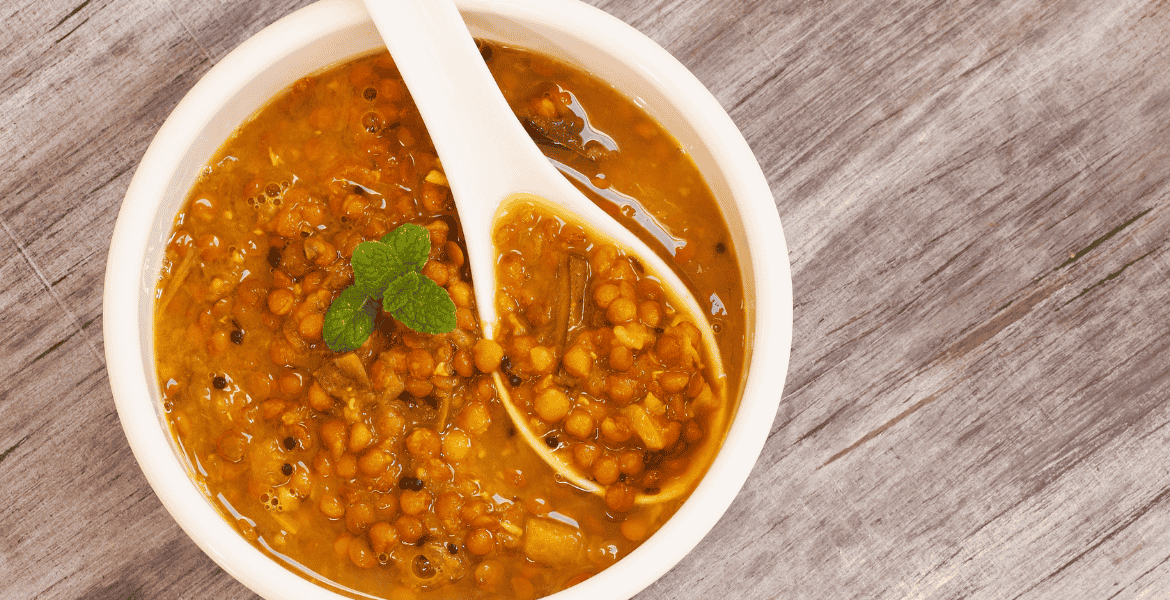 Creamy Sri Lankan dhal curry made with red lentils, coconut milk, and aromatic spices is served as a classic vegetarian dish with rice or roti.