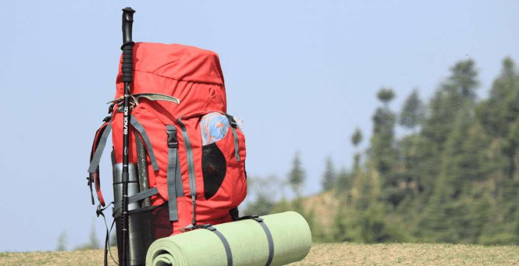 Essential hiking gear for Ella, Sri Lanka, includes a backpack, trekking pole, water bottle, and mat – perfect for exploring scenic trails like Ella Rock and Little Adam's Peak.