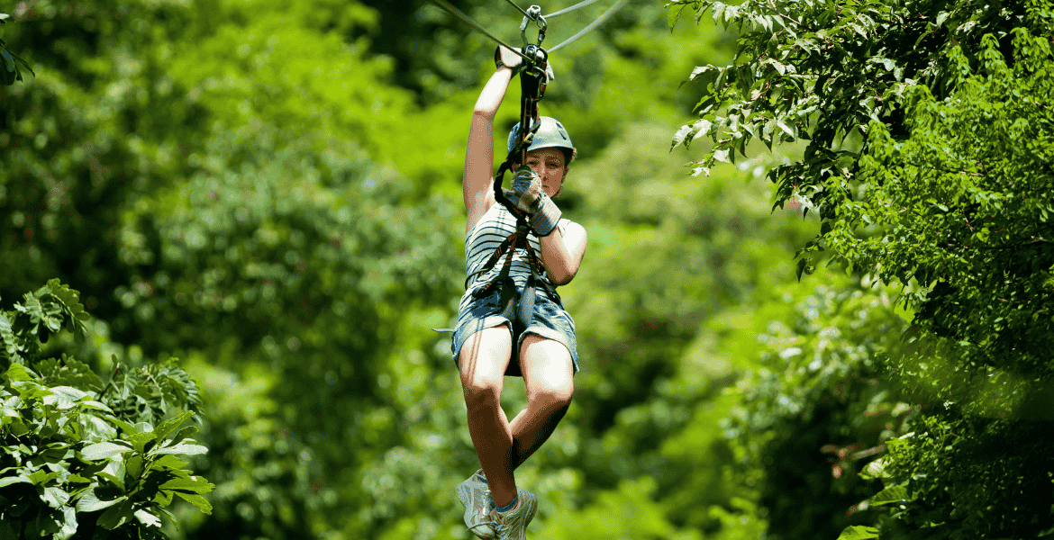 Thrilling zipline ride at Flying Ravana in Ella, Sri Lanka, soaring above lush green bushes and scenic tea plantations.